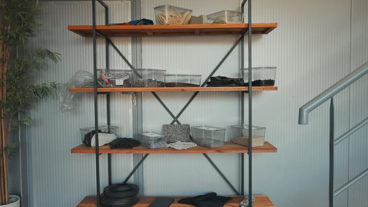 Wooden shelves holding various clear containers and mixed materials