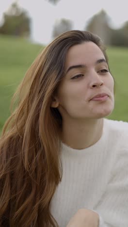 young woman blowing a kiss in a park