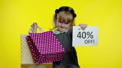 child girl showing up to 40 percent off inscription sign and shopping bags. teen pupil smiling