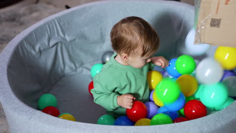 baby playing in a ball pit