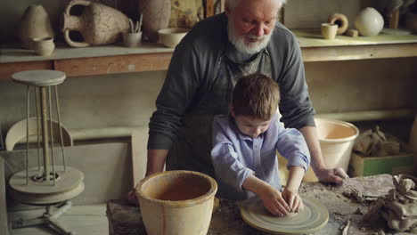 grandfather and grandson making pottery