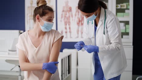 Handheld-video-of-female-doctor-vaccinates-a-patient