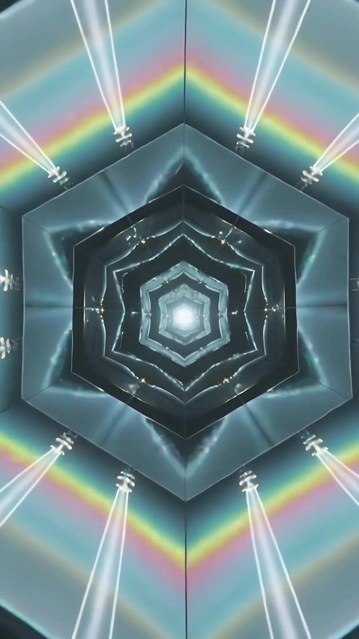 Video verticale: Nucleo luminoso che scintilla, anelli di tunnel esagonali che accendono LED, creando bande prismatiche negli specchi.