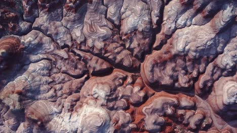 textured background of uneven surface of sandstone cliffs in sunlight