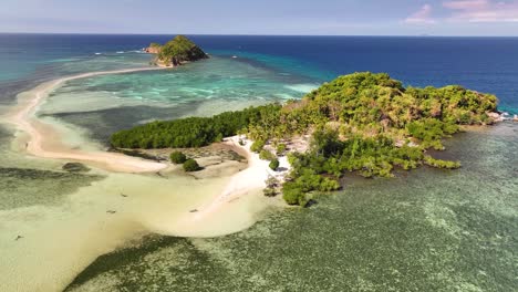 small tropical islands connected by sand bank on philippines shoreline. travel destination.