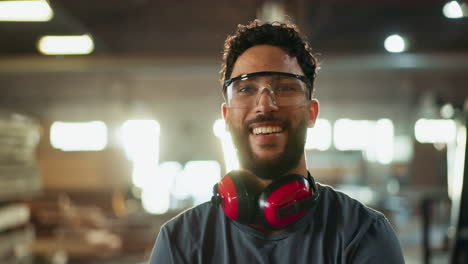 man in woodshop wearing safety glasses and earmuffs