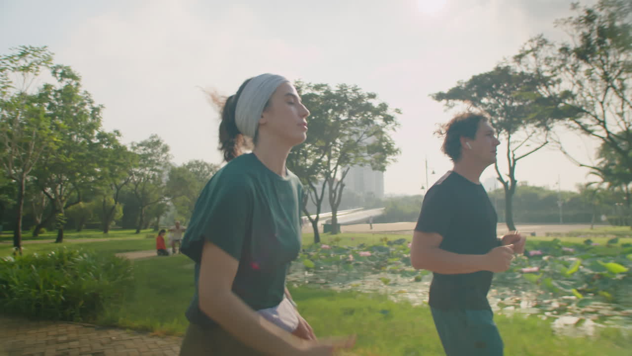 Sporty Couple Jogging Outdoors in Morning