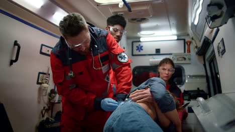 emergency medical doctors giving first aid for victim in emergency car.