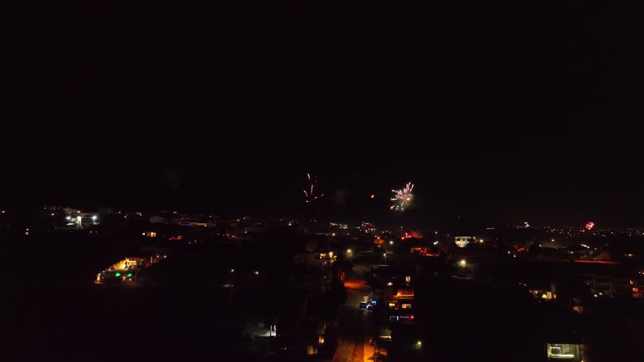 Rooftop perspective over the town with beautiful New Year's Eve fireworks show on the background