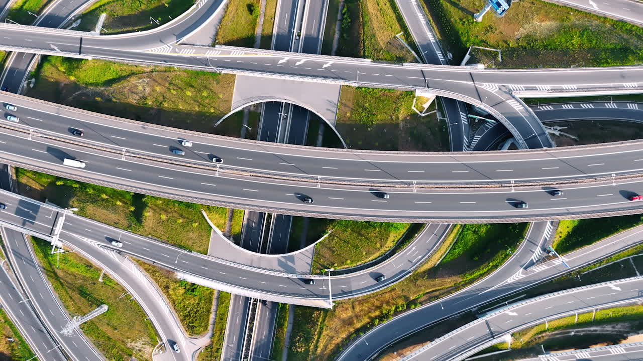 Complex highway interchange in Europe. Aerial view of a busy European highway interchange with multiple lanes and curved road designs