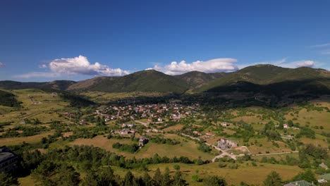 mountain village of voskopoja in albania, surrounded by beautiful hills and green pine forest