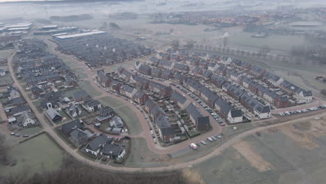 aerial of newly build suburban neighborhood with solar panels on rooftop