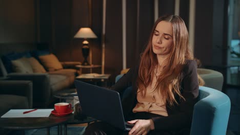 Tired-woman-working-laptop-at-evening-office-lounge.-Exhausted-business-woman