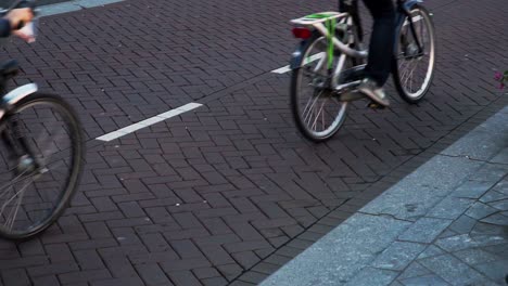 close up of two bikes riding on city street