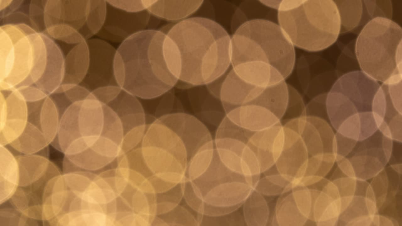 Dynamic zoom video of glittering bokeh lights urban nightscape abstract visuals close-up view