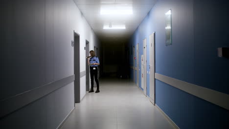 woman in uniform searching on the hallway