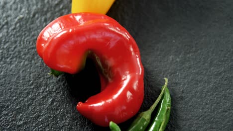 Various-chili-pepper-on-black-background-4k