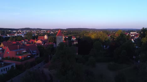 a-drone-rises-slowly-over-the-covered-bridge-overlooking-the-city-and-the-city-wall-with-the-towers