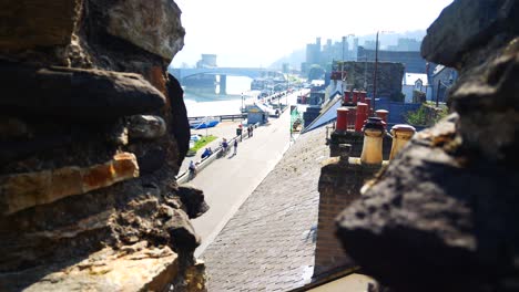 Sunny-Conwy-castle-harbour-sightseeing-Welsh-town-overlooking-from-stone-battlement-walls-dolly-right-above-rooftops