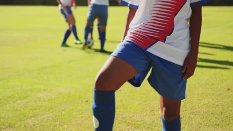 Female-soccer-player-standing-with-one-foot-on-the-ball.-4k