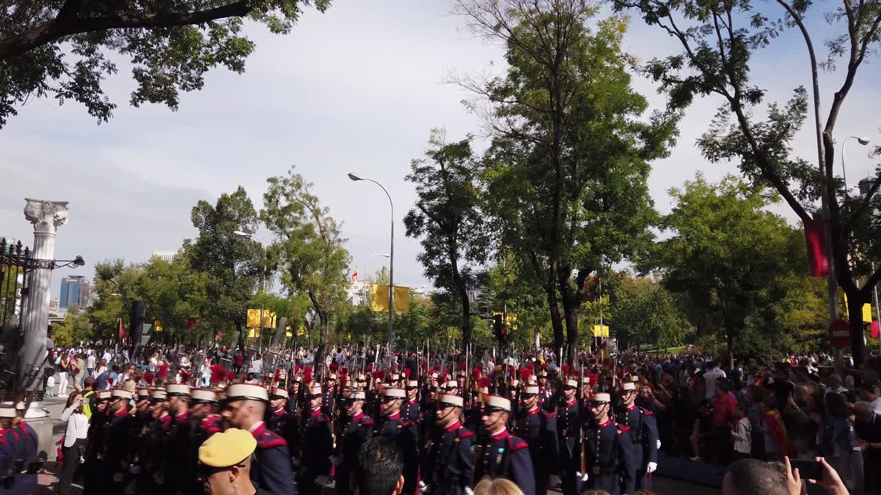 A military parade with soldiers carrying spears