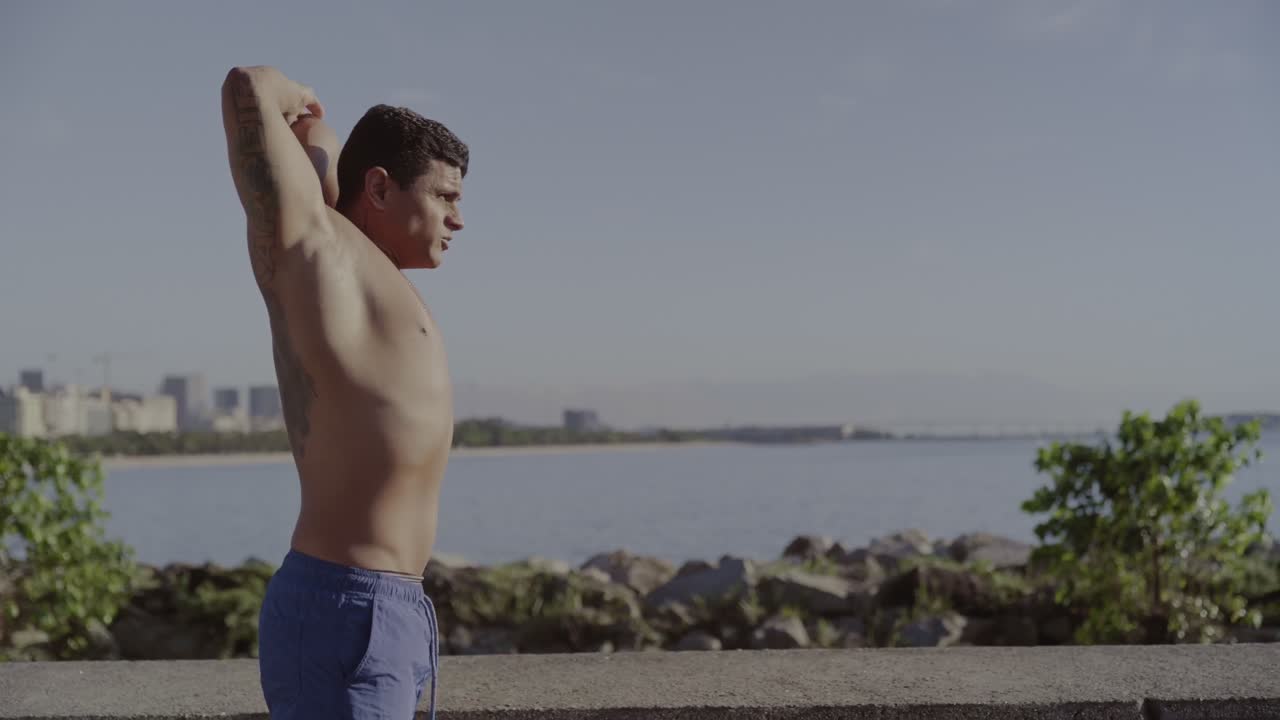 Man Stretching Outdoors by the Water