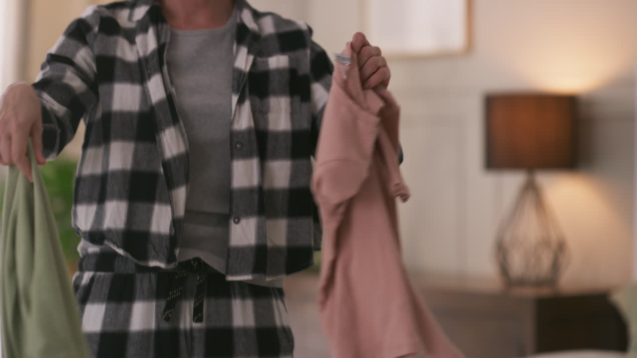 Woman sorting clothes on a bed