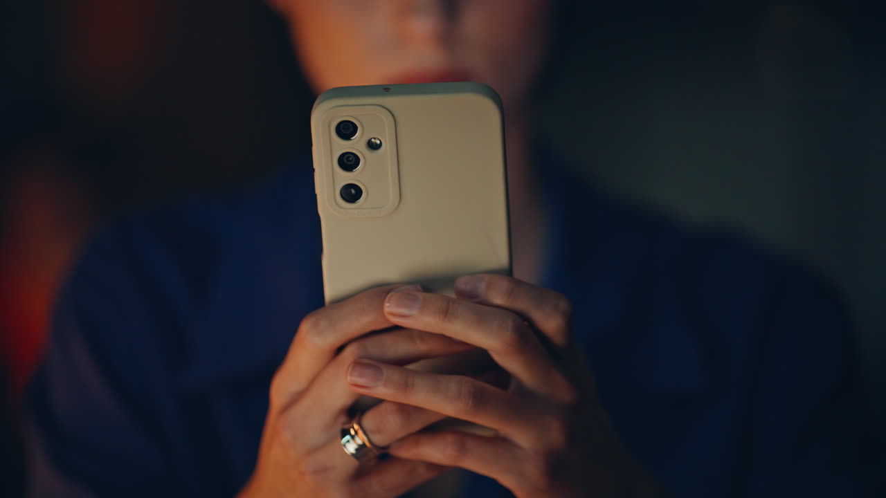 Businesswoman hands texting smartphone at night office closeup. Serious woman