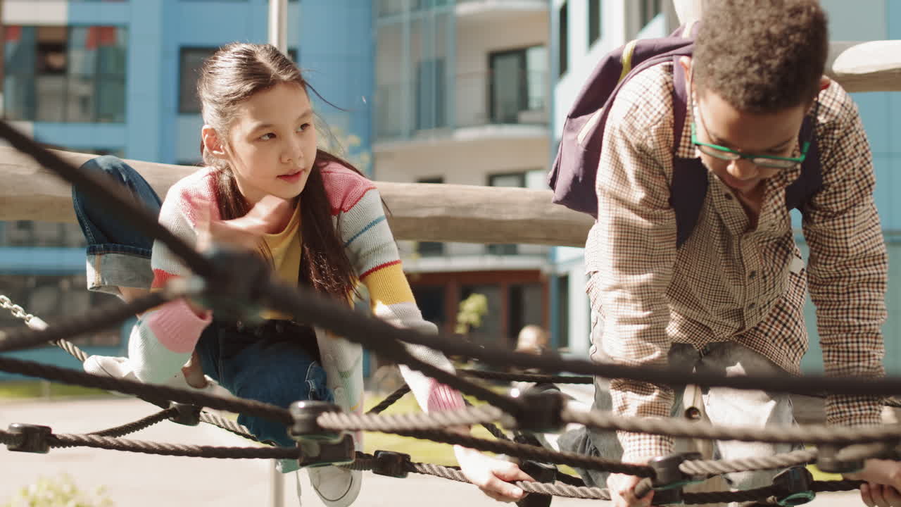 School Children Playing on Climbing Net at Playground
