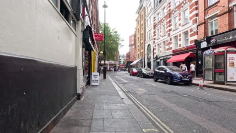 pedestrians and cars on a lively city street