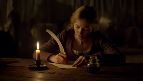 woman writing by candlelight
