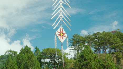 wind chime or dreamcatcher with vietnamese drawings at cu lan folk village vietnam