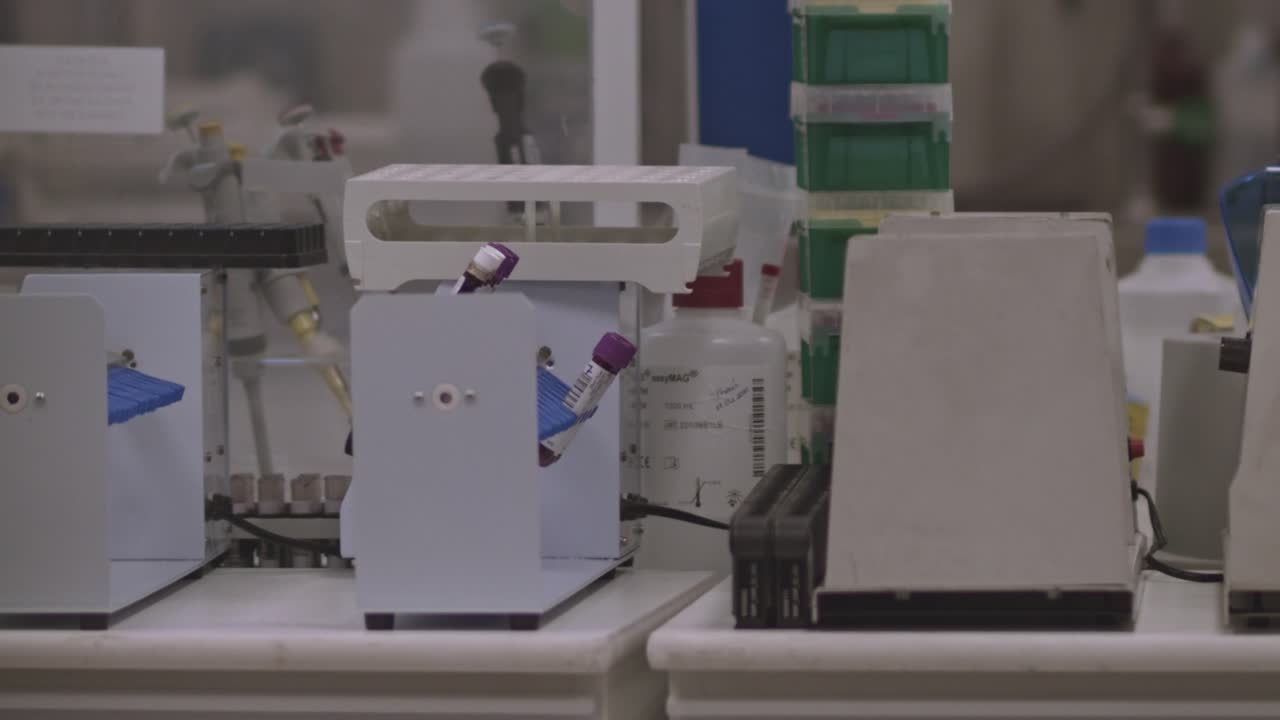 Test tube mixer rotates COVID-19 samples in a medical testing facility.