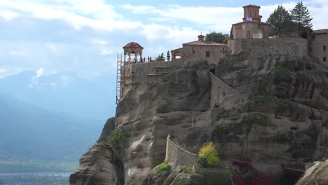 a monastery in meteora greece overlooks a valley below