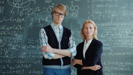 teacher and student in front of a blackboard