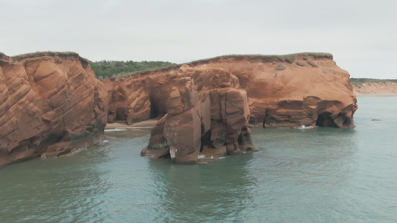 Aerial parallax view of majestic coastal rock formations on Magdalen Islands