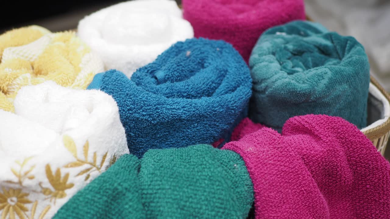 Colorful Rolled Towels in a Basket