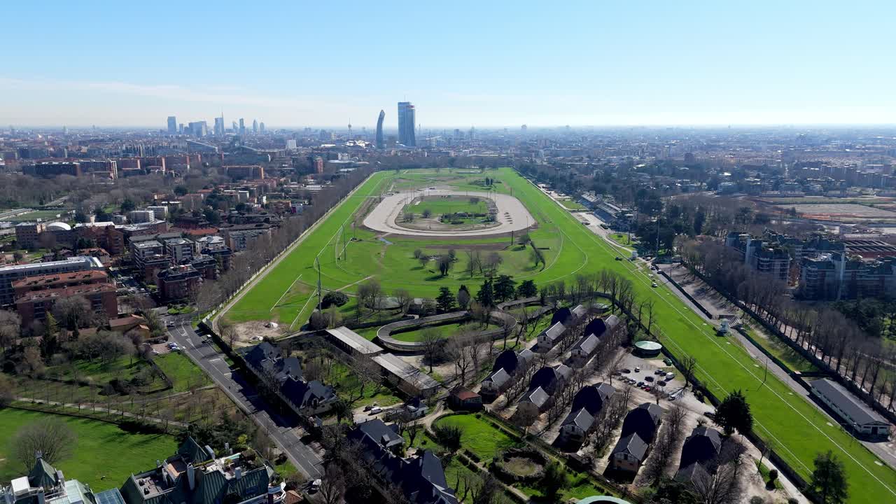 Aerial drone view of Milan’s entire racecourse with city skyline, capturing full track layout, grandstands, and urban landscape from a panoramic perspective drone wide hight angle view