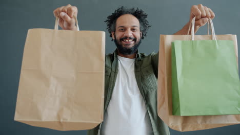 man holding shopping bags