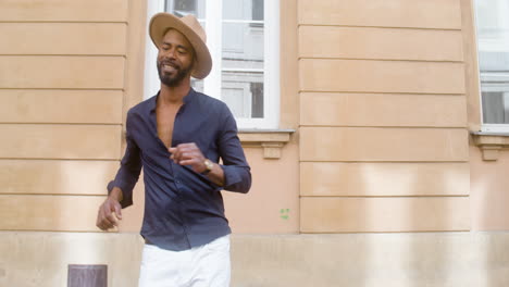 Happy-Afro-Caribbean-Man-With-Panama-Hat-Dancing-Latin-Choreographies-Alone-In-Street-1