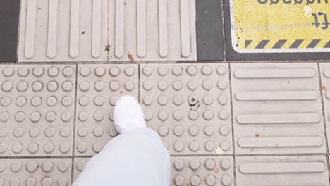 person walking on tactile paving in melbourne