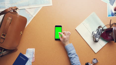 Top-view-woman-traveler-hands-planning-holiday-using-mobile-phone-app-vintage-desk-from-above---Red-Epic-Dragon