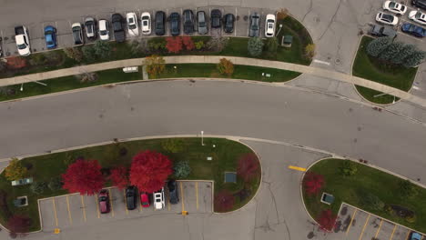 top down aerial view of city street with car parking lot in canada