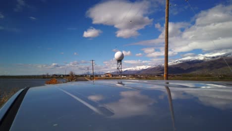 a hyper lapse driving away from a radar tower in the middle of the country