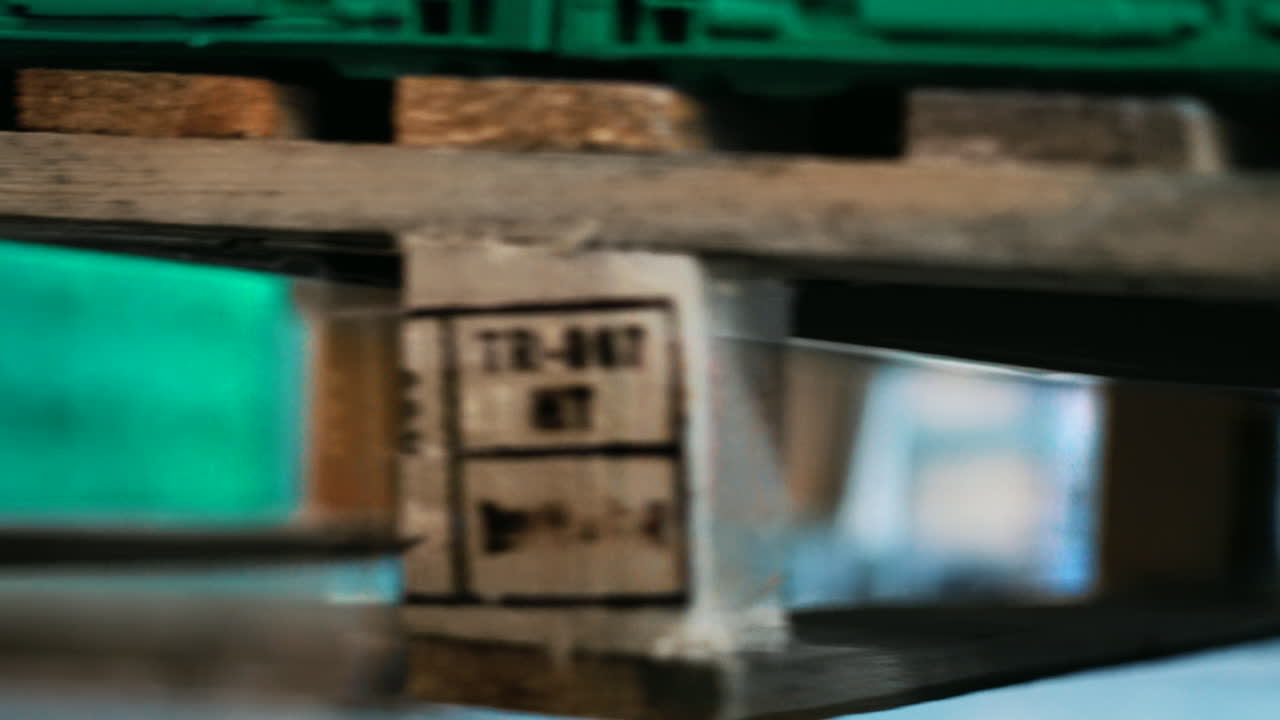 Forklift that lifts a wooden pallet with goods. Detail of the forks