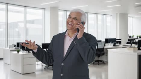 Happy-Indian-senior-manager-talking-on-phone