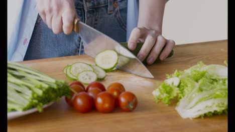 preparing a salad with cucumbers and tomatoes