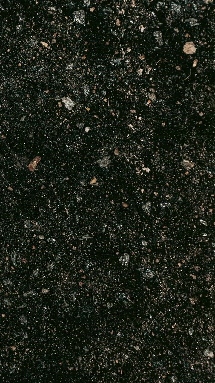 Dark textured granite stone surface