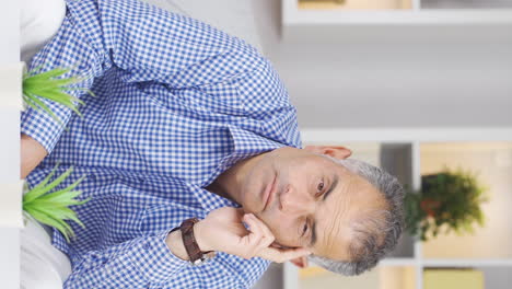 Vertical-video-of-Man-looking-thoughtfully-at-camera.