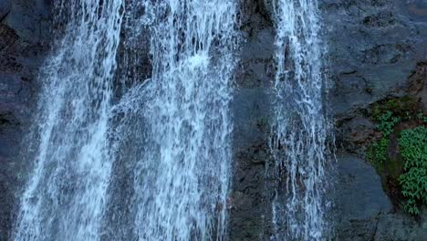 epic waterfall falling into the jungle